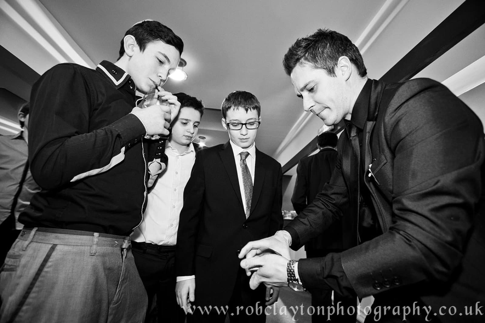 James Anthony performing close-up magic for guests at a bar mitzvah celebration