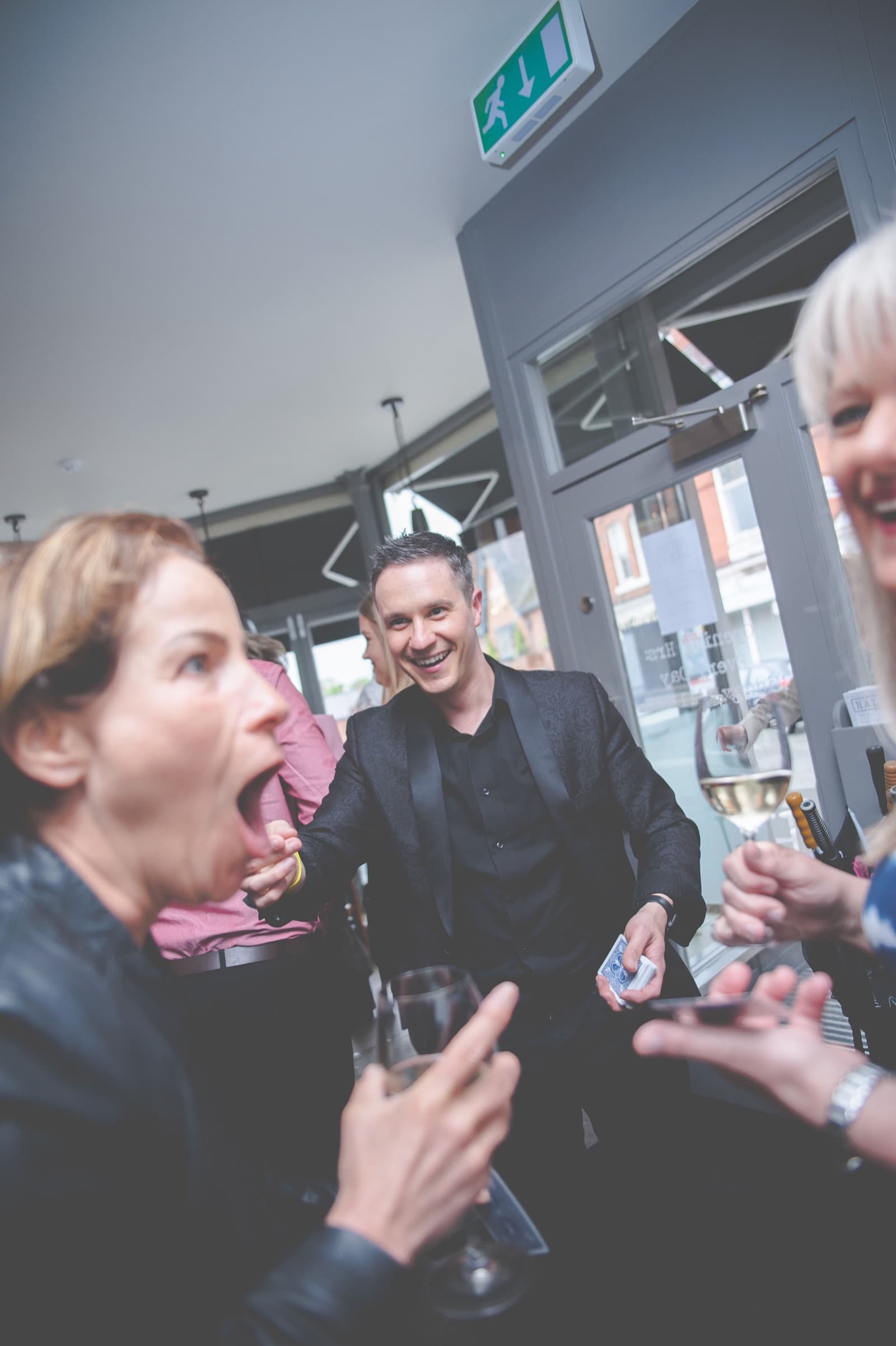 Guests enjoying close-up magic at a Rochdale event