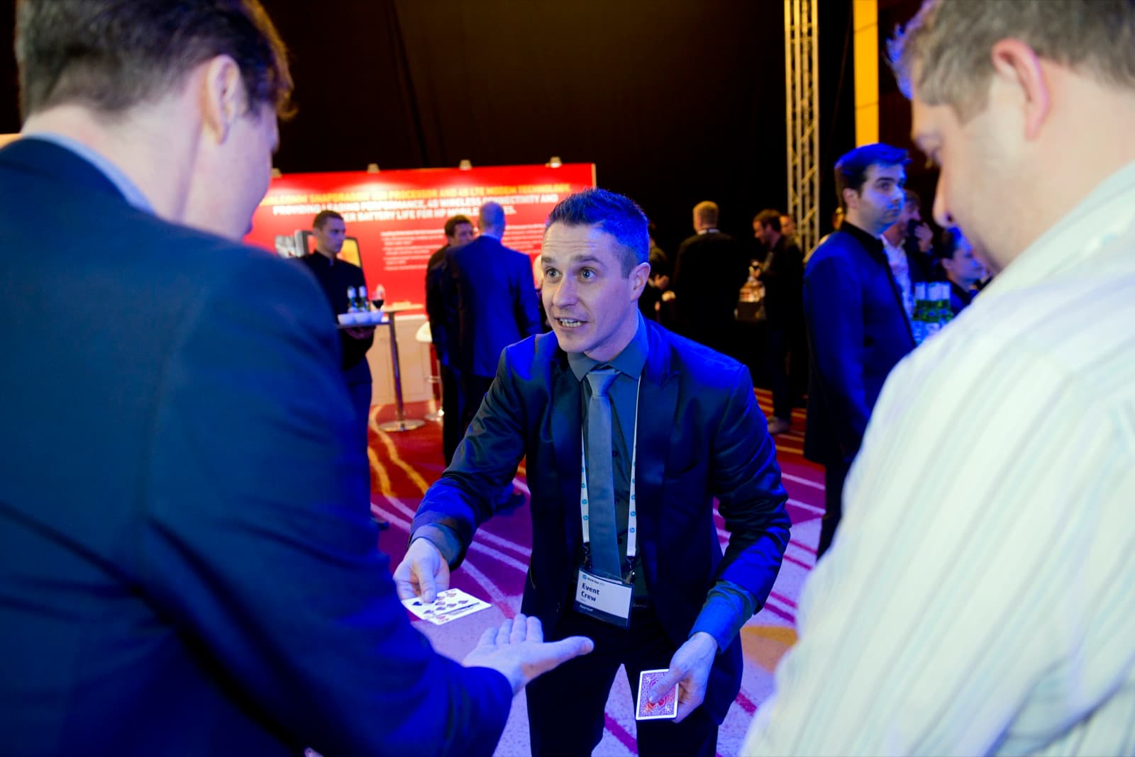James Anthony performing a card trick for a delegate at a conference