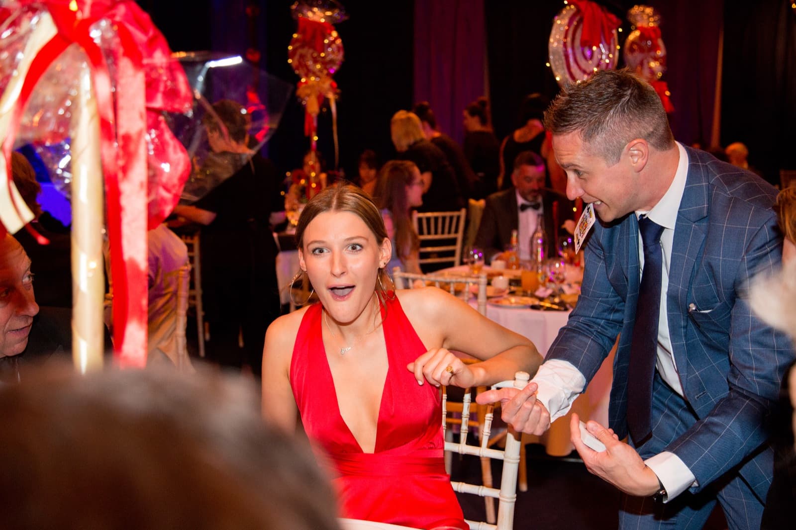 James Anthony performing close-up magic at a corporate gala — guest's jaw-dropping reaction