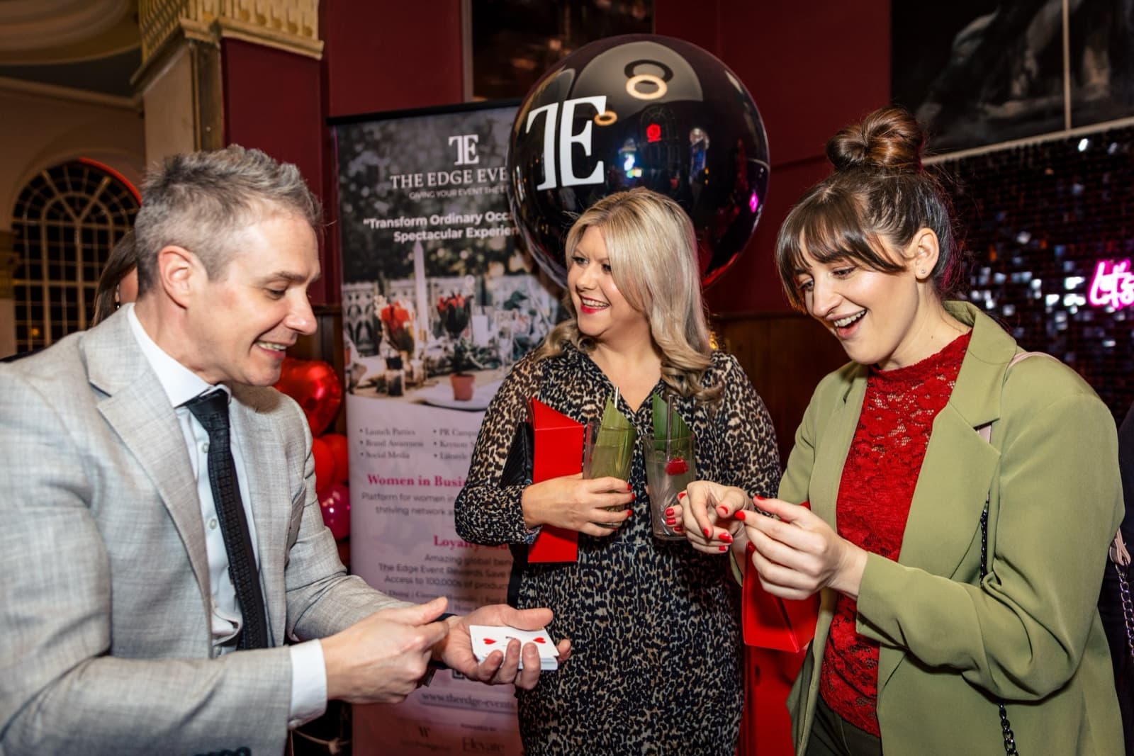 James Anthony showing a card to guests at a private event