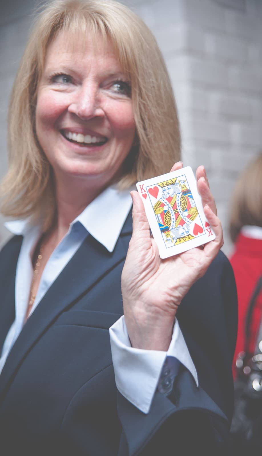 Guest smiling with a chosen card at a private celebration
