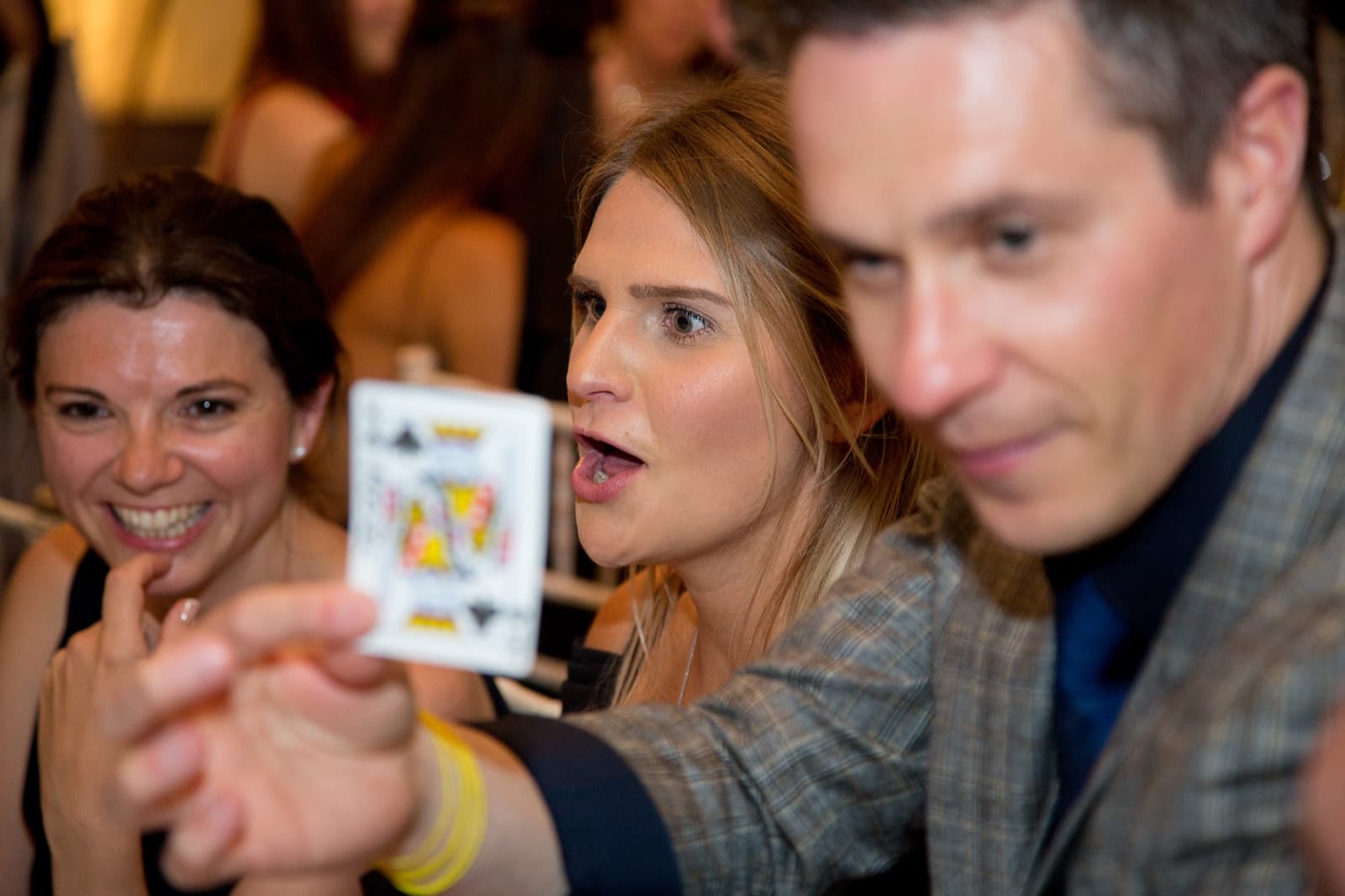 Close-up of a playing card being revealed to prom guests by James Anthony