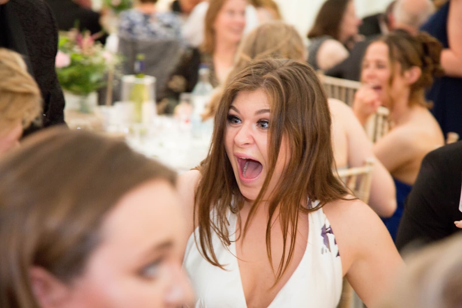 A guest's shocked reaction to a close-up magic trick at a party