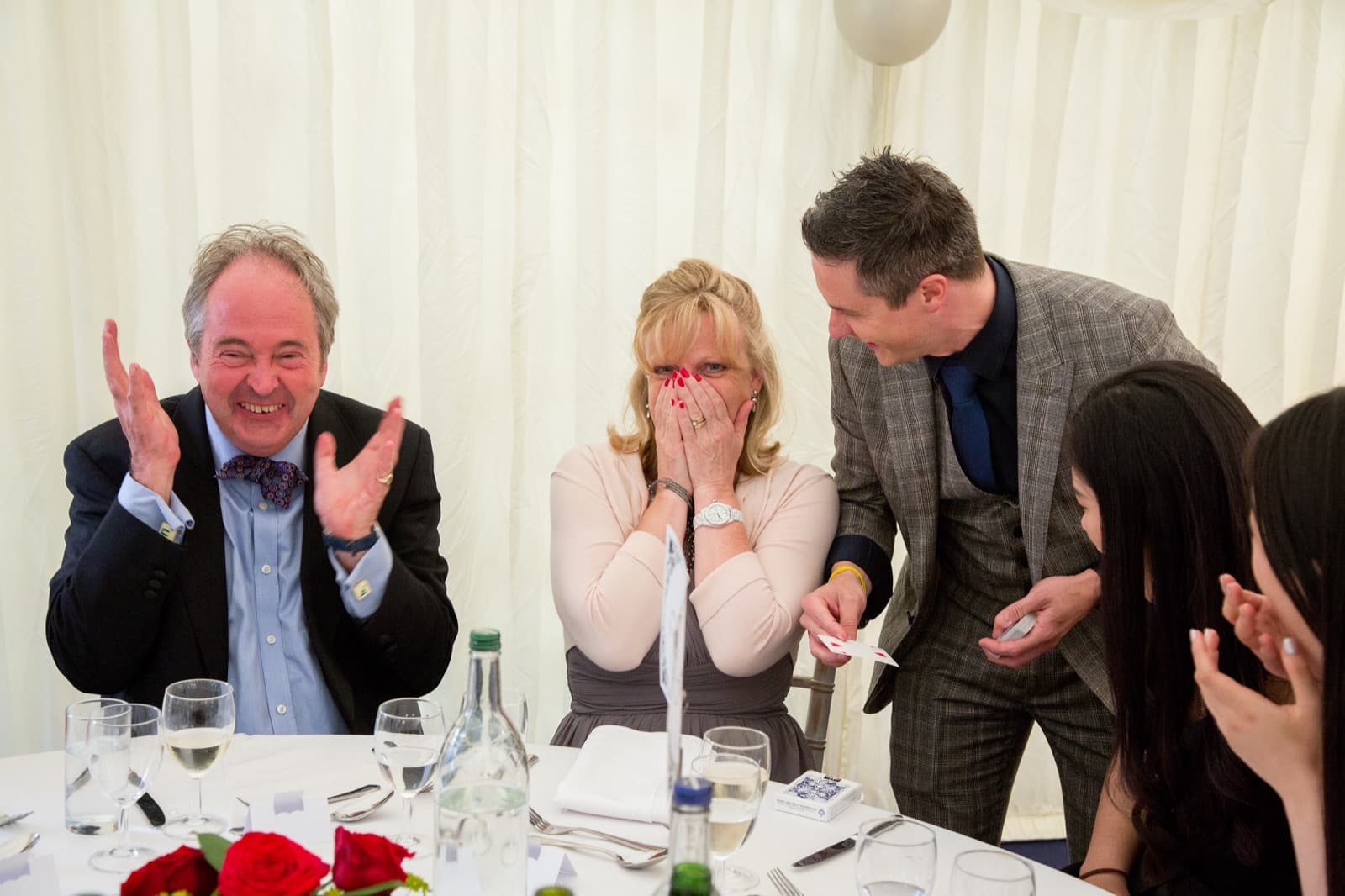 Guests applauding after a magic trick by James Anthony at a party