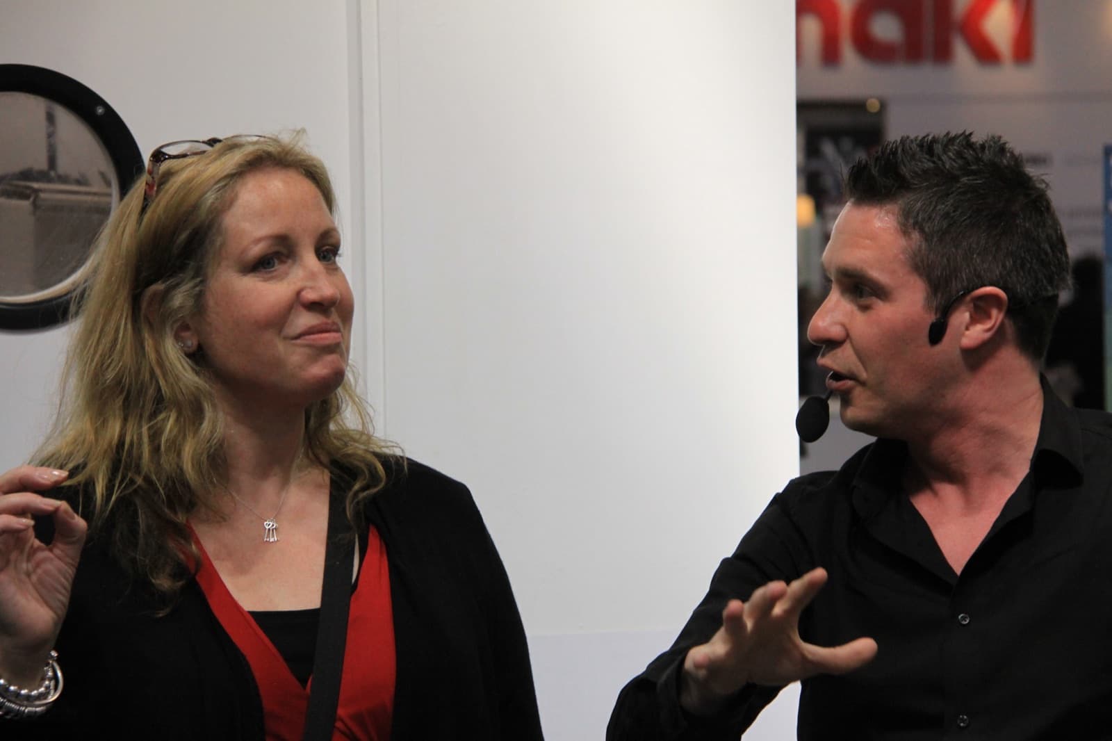 James Anthony performing magic for a visitor at an exhibition stand