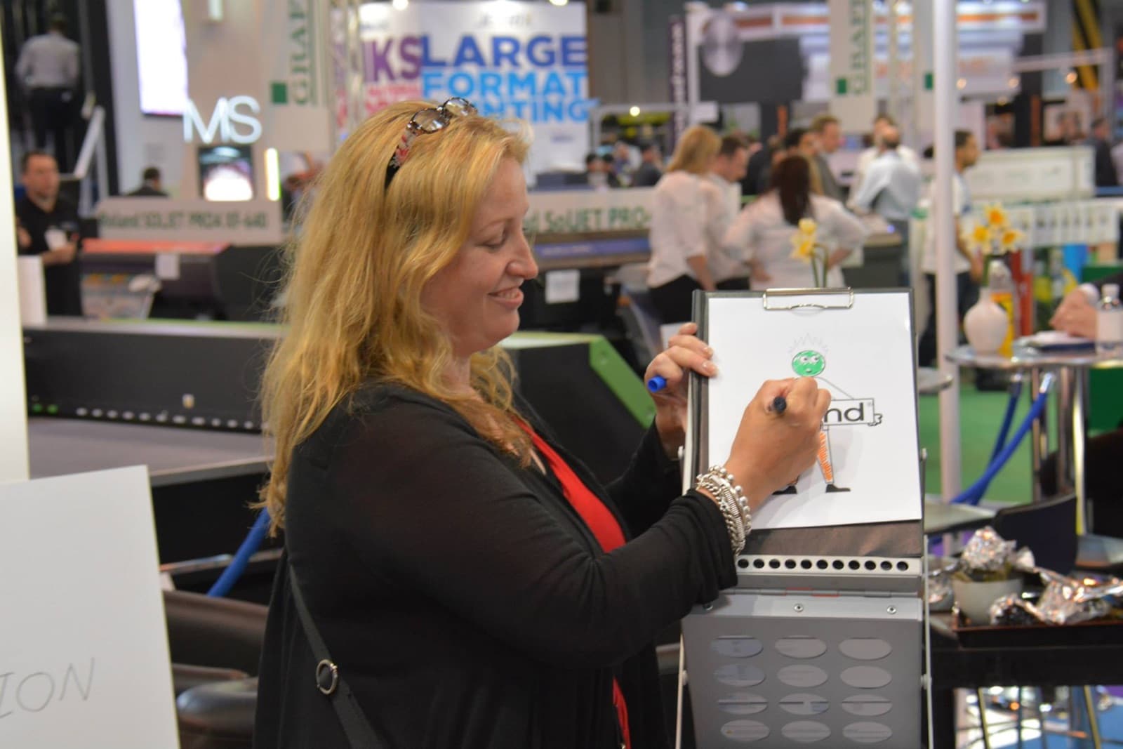 Trade show visitors watching James Anthony at an exhibition stand