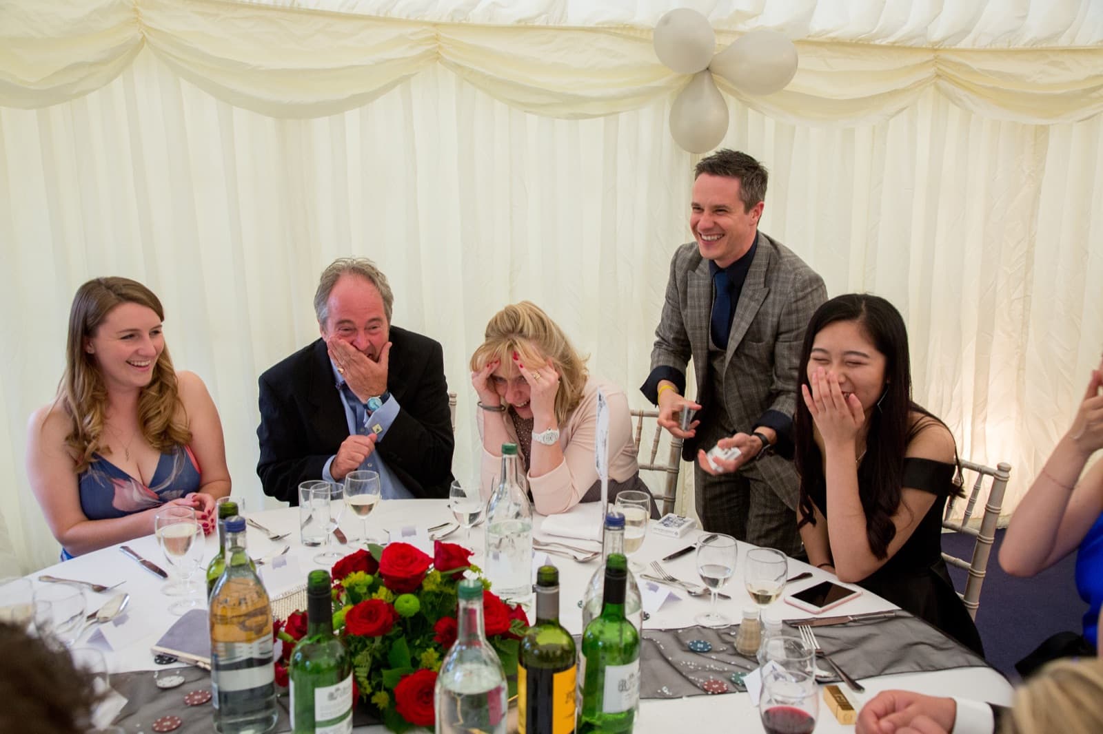 James Anthony performing close-up magic at a wedding in a luxury marquee